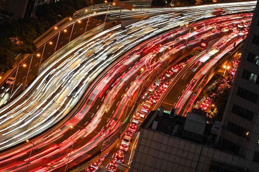 A slow shutter speed photograph shows commuters on vehicles making their way along a busy highway in Shanghai, China, on 7 September 2021. (Hector Retamal/AFP)