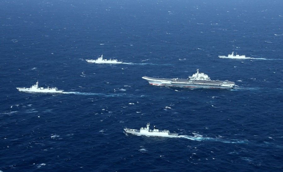 This aerial file photo taken on 2 January 2017 shows a Chinese Navy formation, including the aircraft carrier Liaoning (C), during military drills in the South China Sea. US Secretary of State Mike Pompeo said on 13 July 2020 the United States would treat Beijing's pursuit of resources in the dispute-rife South China Sea as illegal, ramping up support for Southeast Asian nations and triggering a furious response from Beijing. (STR/AFP)