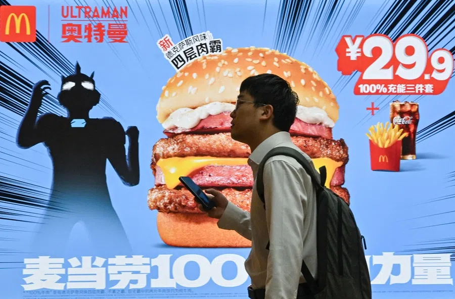 A man walks past a McDonald’s advertisement at a subway station in Beijing, China, on 11 June 2025. (Adek Berry/AFP)