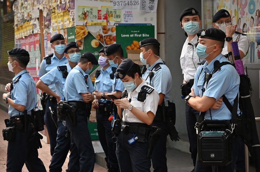 Police gather as the League of Social Democrats prepares to hold a protest against Beijing's plan to change Hong Kong's electoral system in Hong Kong on 17 March 2021. (Peter Parks/AFP)