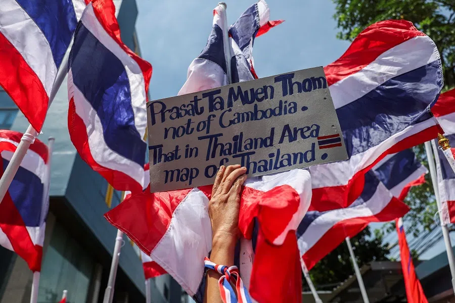A royalist activist holds a placard as she protests in front of the Royal Embassy of Cambodia, following a recent clash at the Thailand-Cambodia border on 28 May 2025, in Bangkok, Thailand, on 6 June 2025. (Chalinee Thirasupa/Reuters)