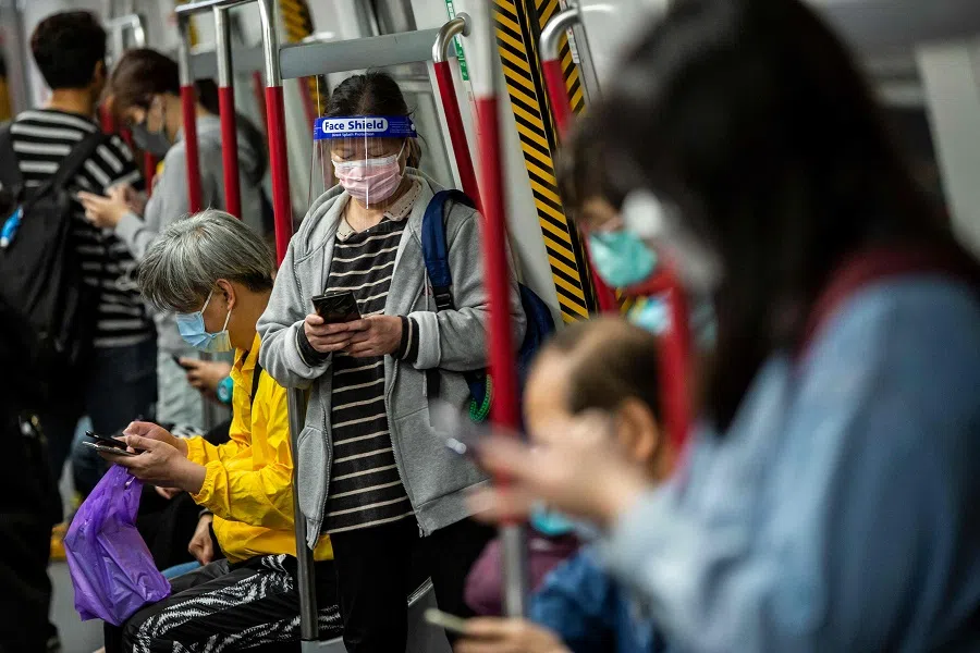 Passengers ride the MTR train in Hong Kong on 3 March 2022, amid the city's Covid-19 outbreak. (Isaac Lawrence/AFP)