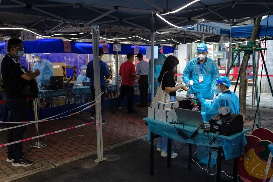 A pedestrian shows her health code in Macau, China on 27 October 2022. (Bloomberg)