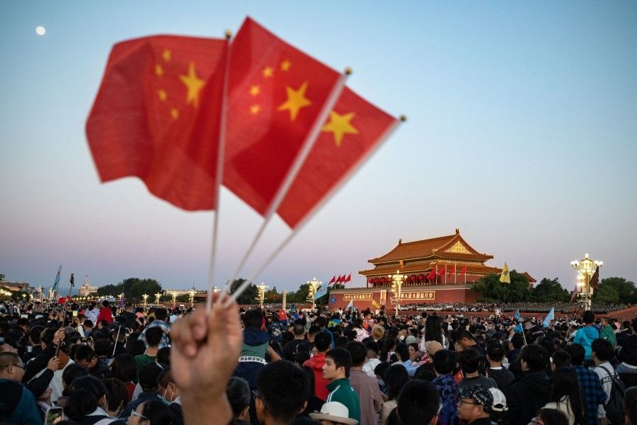 Visitors gather for the flag raising ceremony at Tiananmen Square to mark National Day in Beijing, China, on 1 October 2023. (Andrea Verdelli/Bloomberg)