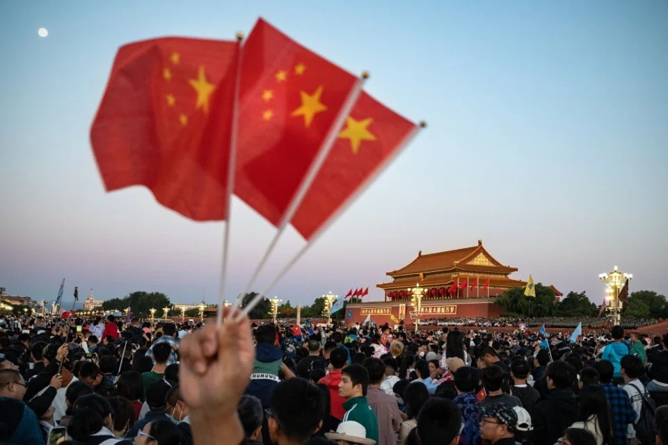 Visitors gather for the flag raising ceremony at Tiananmen Square to mark National Day in Beijing, China, on 1 October 2023. (Andrea Verdelli/Bloomberg)