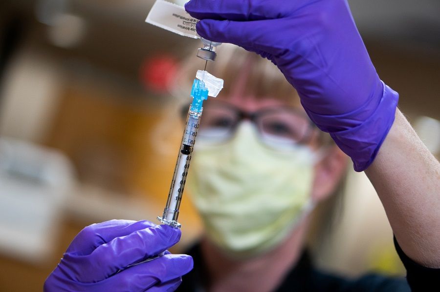 A dose of the Pfizer Covid-19 vaccine is prepared at UW Health in Madison, Wisconsin, US, 14 December 2020. (John Maniaci/UW Health/Handout via Reuters)