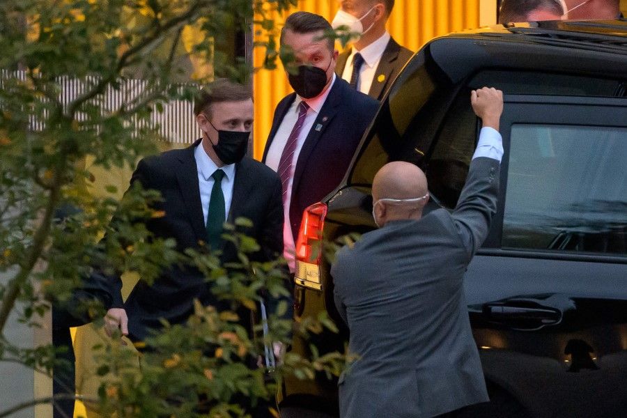 US national security adviser Jake Sullivan (left) leaves the Hyatt hotel where US and China top officials holding talks in Zurich Airport on 6 October 2021. (Fabrice Coffrini/AFP)
