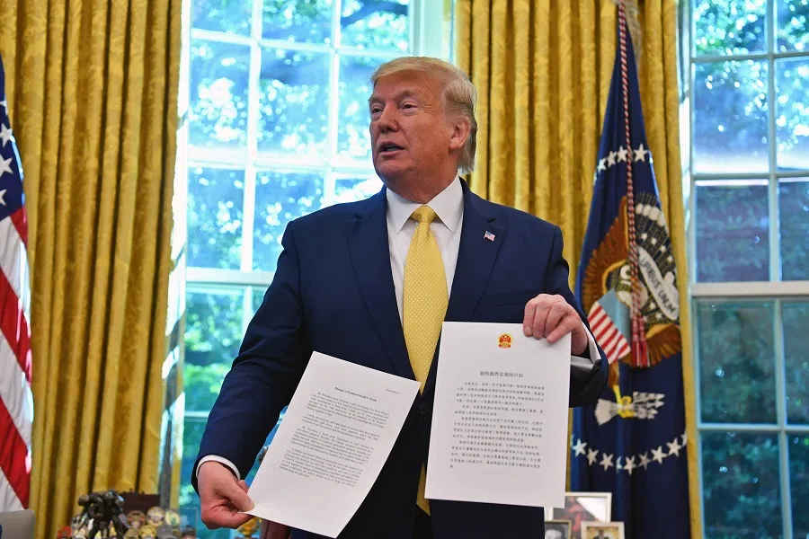 US President Donald Trump showing a letter from Chinese President Xi Jinping when he announced an initial deal in October 2019. (Nicholas Kamm/AFP)