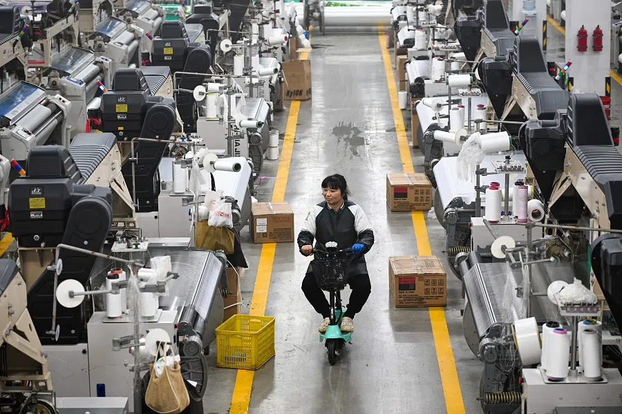 A woman works at a texile factory in Siyang County of Suqian municipality in east China’s Jiangsu province on 24 December 2024. (AFP)