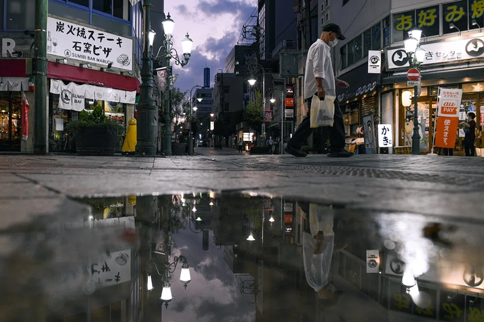 A pedestrian walks on a street near Hamamatsu station in Hamamatsu, Shizuoka Prefecture, Japan, on 6 October 2021. (Noriko Hayashi/Bloomberg)