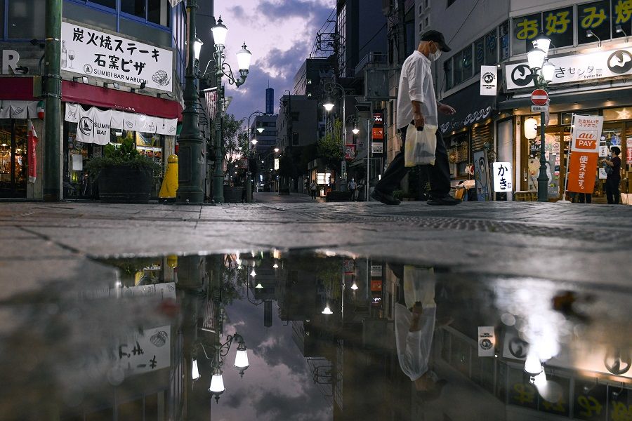 A pedestrian walks on a street near Hamamatsu station in Hamamatsu, Shizuoka Prefecture, Japan, on 6 October 2021. (Noriko Hayashi/Bloomberg)