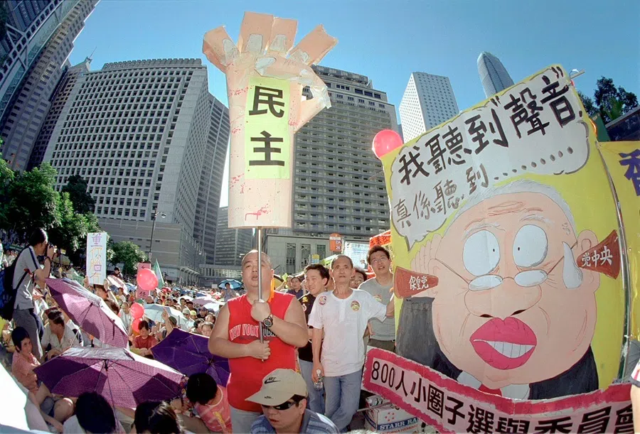 Protesters chant slogans calling for political reforms, including direct elections on the territory’s chief executive, during a rally in Hong Kong on 13 July 2003.