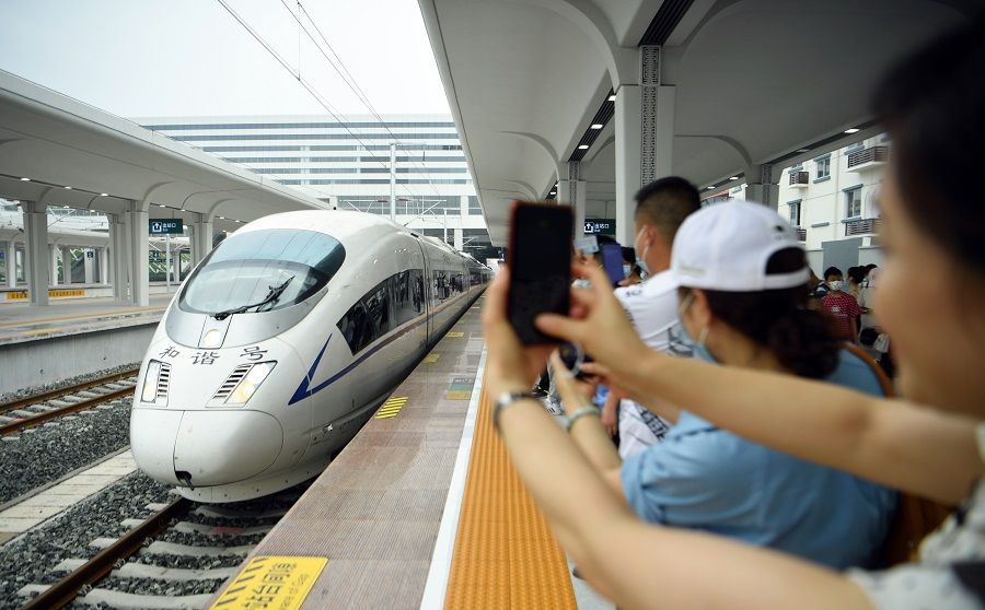 People take photos on the platform as a train arrives at Zigong Railway Station in Sichuan, China, on 28 June 2021, the first day of its operations. (CNS)