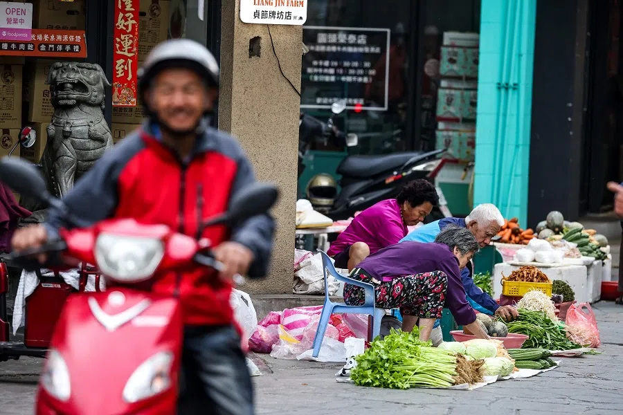 People shop at a local traditional market in Kinmen, Taiwan, on 18 May 2024.