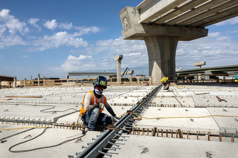 A welder works on an overpass on the Irving Interchange infrastructure project at the site of the former Dallas Cowboys Stadium on 10 August 2022 in Irving, Texas, US. (John Moore/Getty Images/AFP)