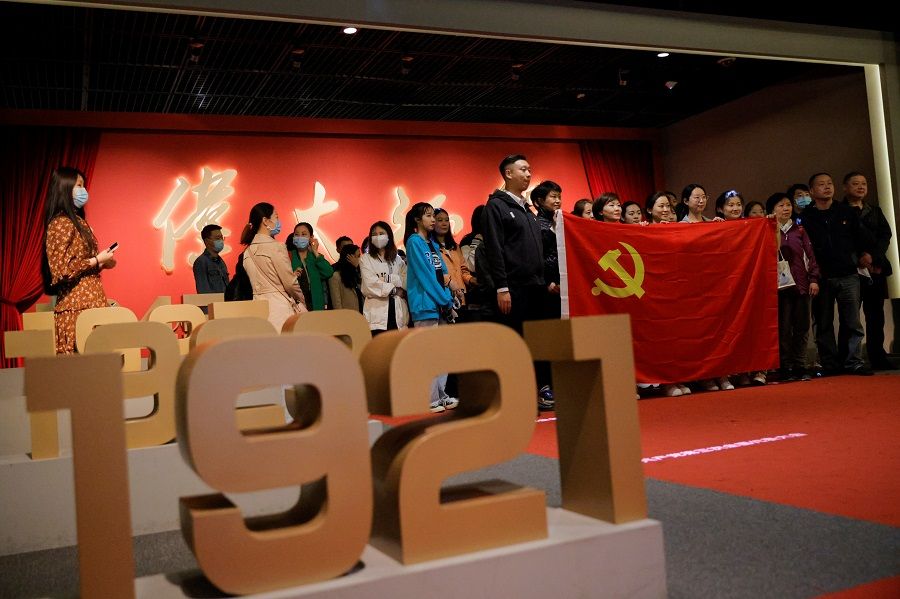 People at an exhibition marking the 100th founding anniversary of the Chinese Communist Party (CCP) in Beijing, China, 22 April 2021. (Thomas Peter/Reuters)