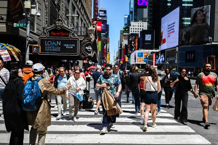Pedestrians and cars move along the Times Square area in the Manhattan borough of New York City on 19 May 2025.