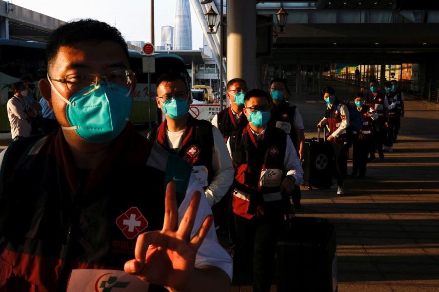 Medical workers from China arrive at Shenzhen Bay Port during the Covid-19 pandemic in Hong Kong, China, 14 March 2022. (Tyrone Siu/Reuters)