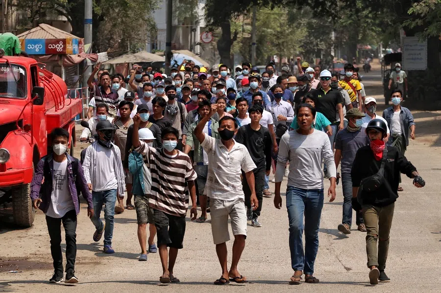 Anti-coup demonstrators gesture as they march in Nyaung-U, Myanmar, 17 March 2021 in this image obtained by Reuters.