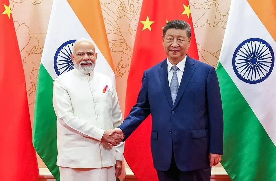 In this handout photograph taken on 31 August 2025 and released by the Indian Press Information Bureau (PIB), India’s Prime Minister Narendra Modi and China’s President Xi Jinping shake hands during a bilateral meeting on the sidelines of the Shanghai Cooperation Organisation (SCO) summit in Tianjin.