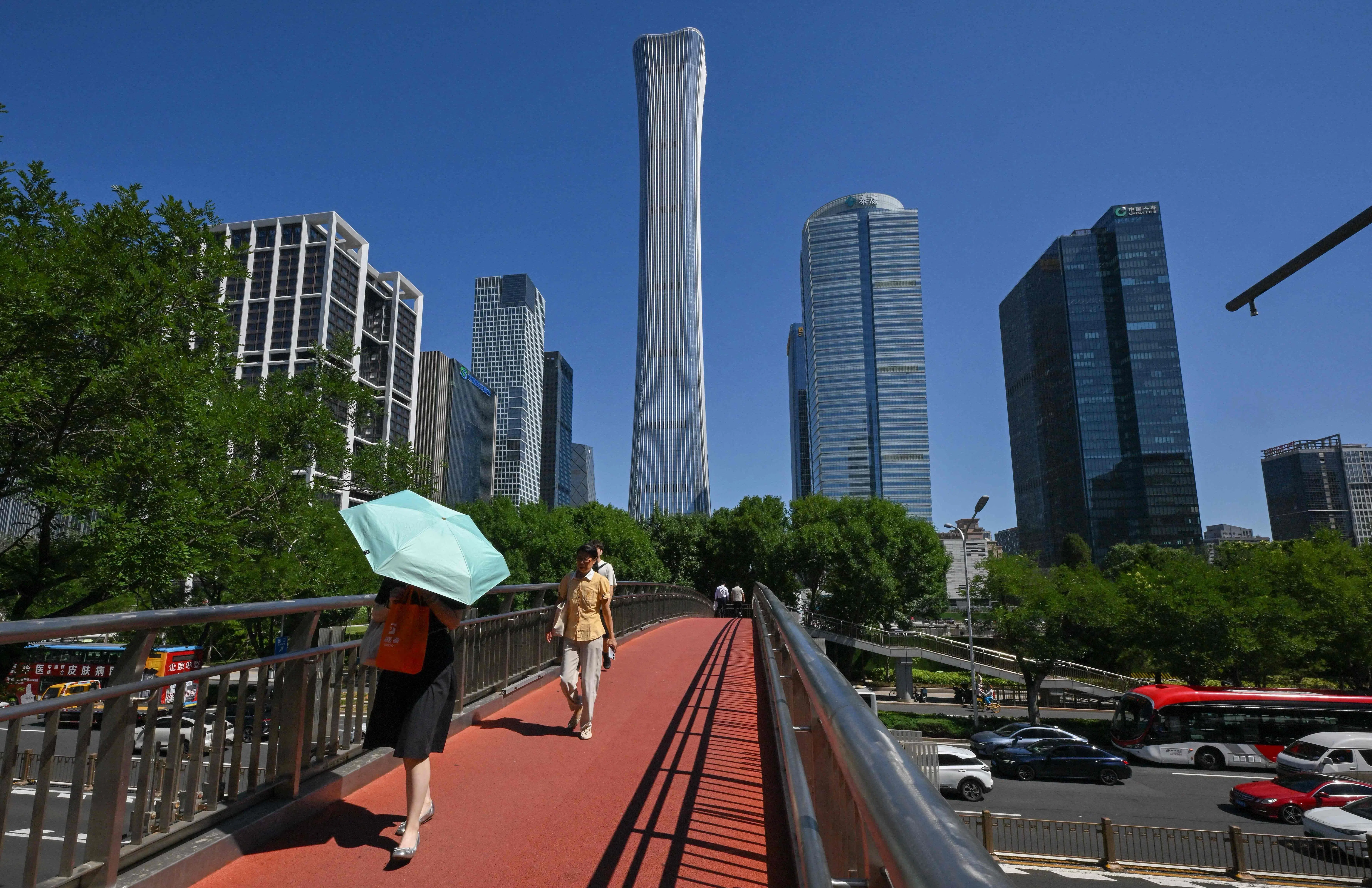 People walk across a bridge in Beijing on 15 July 2026.