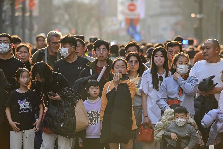 People visit a pedestrian street on the Bund in Shanghai, China, on 14 February 2024. (Hector Retamal/AFP)