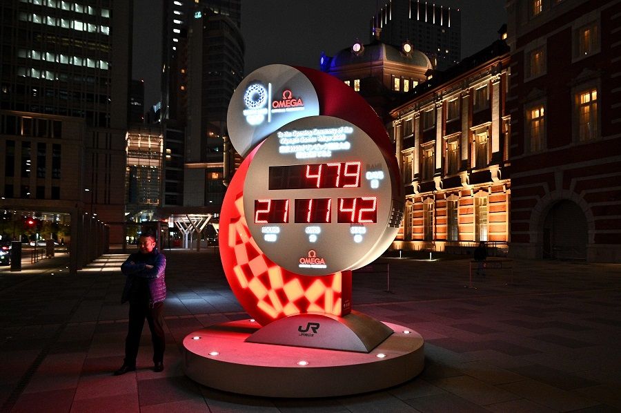 A countdown clock shows the adjusted time remaining for the postponed Tokyo Olympic Games outside Tokyo station, in Tokyo on 30 March 2020. (Philip Fong/AFP)