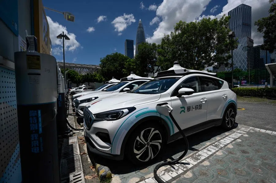 This photo taken on 10 July 2022 shows "robotaxi" autonomous vehicles developed by Baidu Apollo charging at a charging station in Shenzhen, in China's southern Guangdong province. (Jade Gao/AFP)