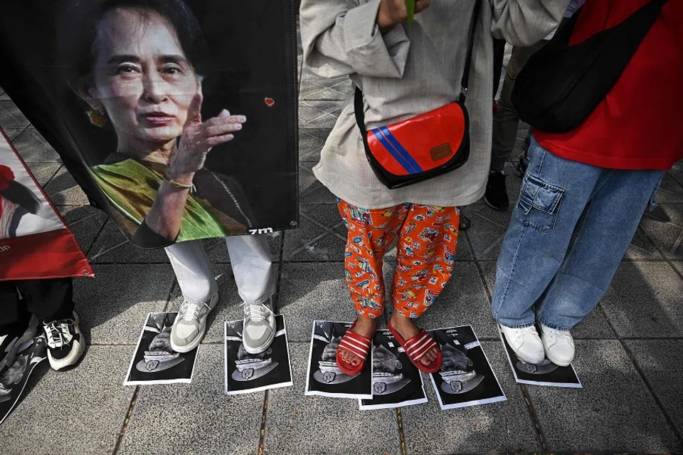 Protesters step on images of Myanmar's army general Min Aung Hlaing during a demonstration outside the UN office in Bangkok on 1 February 2024, to mark the third anniversary of the coup in Myanmar. (Lillian Suwanrumpha/AFP)