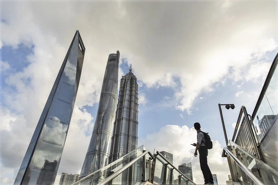 A pedestrian pauses on a footbridge in the Lujiazui business district in Shanghai, China on 20 July 2021. (Qilai Shen/Bloomberg)