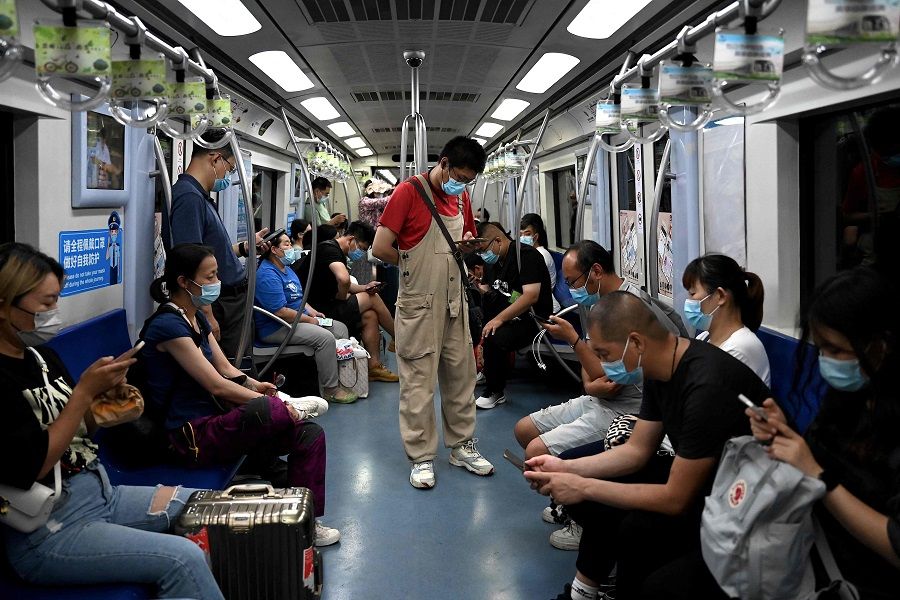 People wearing face masks travel in a subway in Beijing, China, on 6 July 2022. (Noel Celis/AFP)
