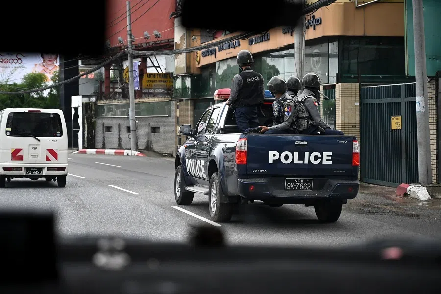 Police patrol on a street in Yangon, Myanmar, on 19 July 2022, on the 75th Martyrs' Day which marks the anniversary of the assassination of independence leaders including general Aung San, father of the currently deposed and imprisoned leader Aung San Suu Kyi. (AFP)