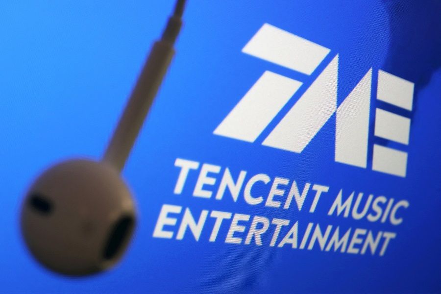 The logo of China's Tencent Music Entertainment Group is seen next to an earphone in this illustration picture taken 22 March 2021. (Florence Lo/Illustration/Reuters)