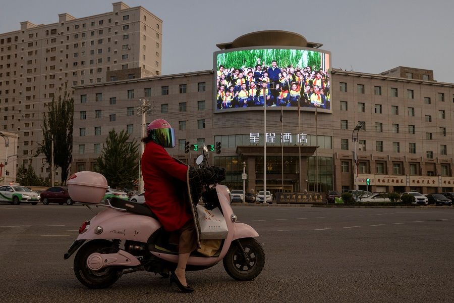 A screen shows a picture of Chinese President Xi Jinping at a traffic junction in Hotan, Xinjiang, China, 30 April 2021. (Thomas Peter/File Photo/Reuters)