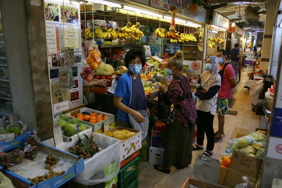 Customers buy fruits at a market in Singapore. (SPH)