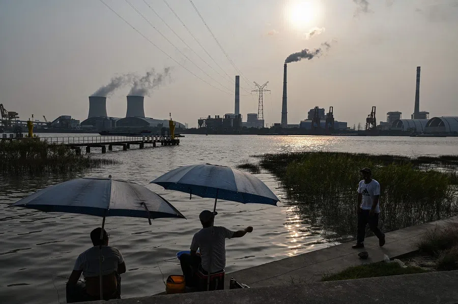 Anglers fish along the Huangpu river across the Wujing Coal-Electricity Power Station in Shanghai, China, on 28 September 2021. (Hector Retamal/AFP)