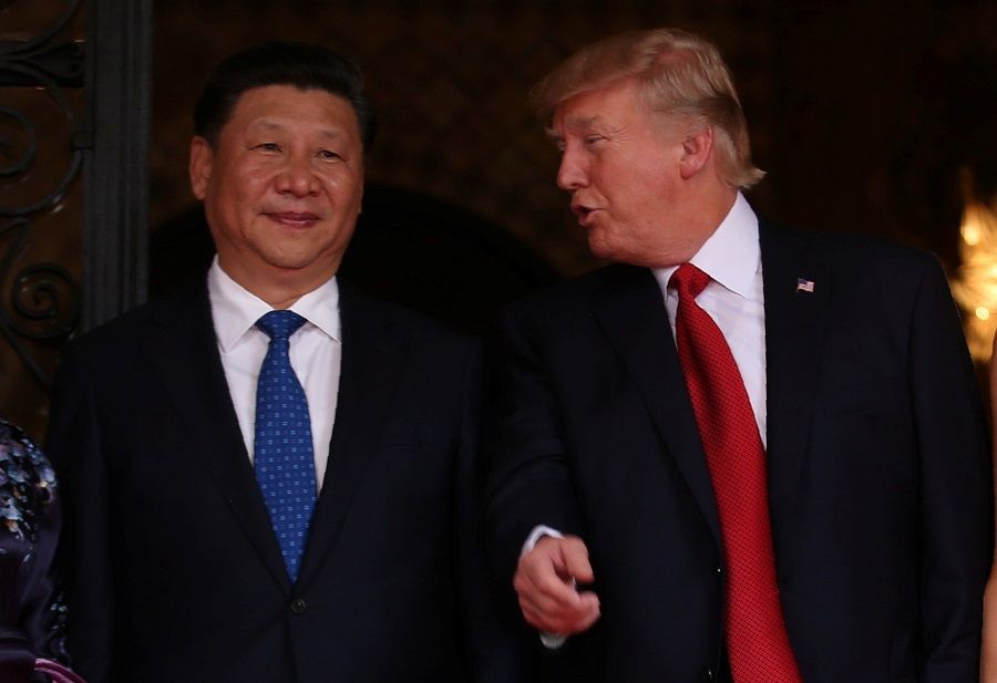 US President Donald Trump (right) talks with Chinese President Xi Jinping as Xi arrives for dinner at the start of their summit at Trump's Mar-a-Lago estate in Palm Beach, Florida, US, 6 April 2017. (Carlos Barria/File Photo/Reuters)