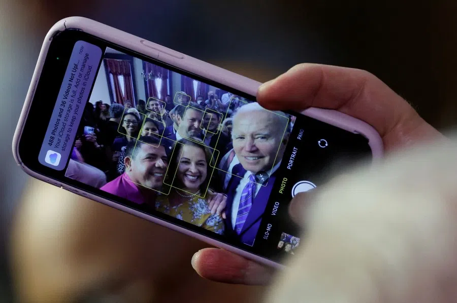 US President Joe Biden holds an attendee's phone to take a selfie after delivering remarks on Social Security and Medicare at the University of Tampa in Tampa, Florida, US, 9 February 2023. (Jonathan Ernst/Reuters)