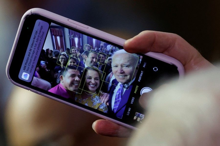 US President Joe Biden holds an attendee's phone to take a selfie after delivering remarks on Social Security and Medicare at the University of Tampa in Tampa, Florida, US, 9 February 2023. (Jonathan Ernst/Reuters)
