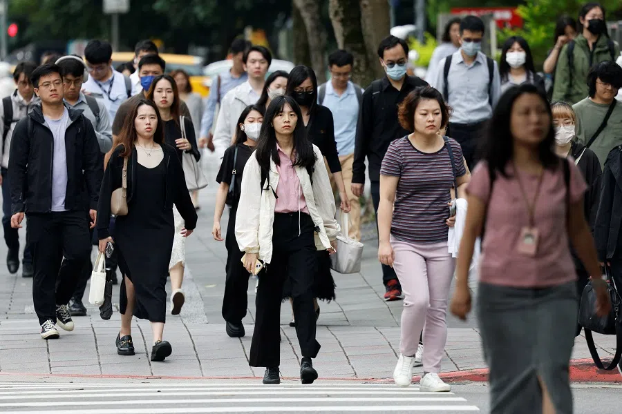 People walk on the street during morning rush hour in Taipei, Taiwan on 23 May 2024. (Carlos Garcia Rawlins/Reuters)
