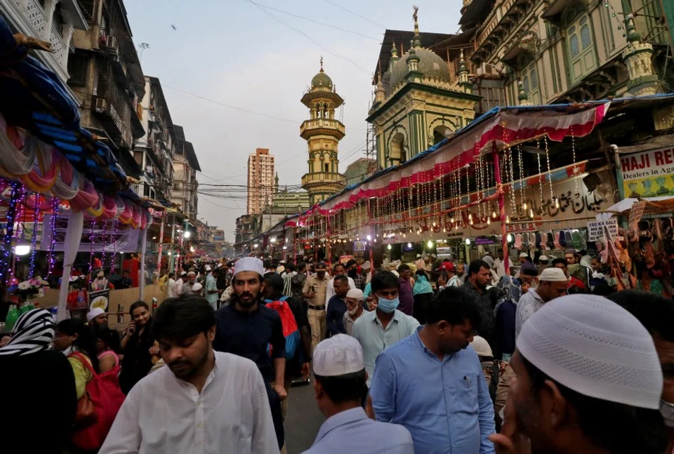 People in a busy street in Mumbai, India, 12 April 2022. (Niharika Kulkarni/Reuters)