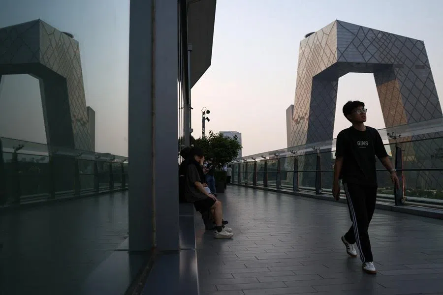 People visit the terrace of a shopping mall overlooking the central business district in Beijing, China, 12 May 2026. (Tingshu Wang/Reuters)