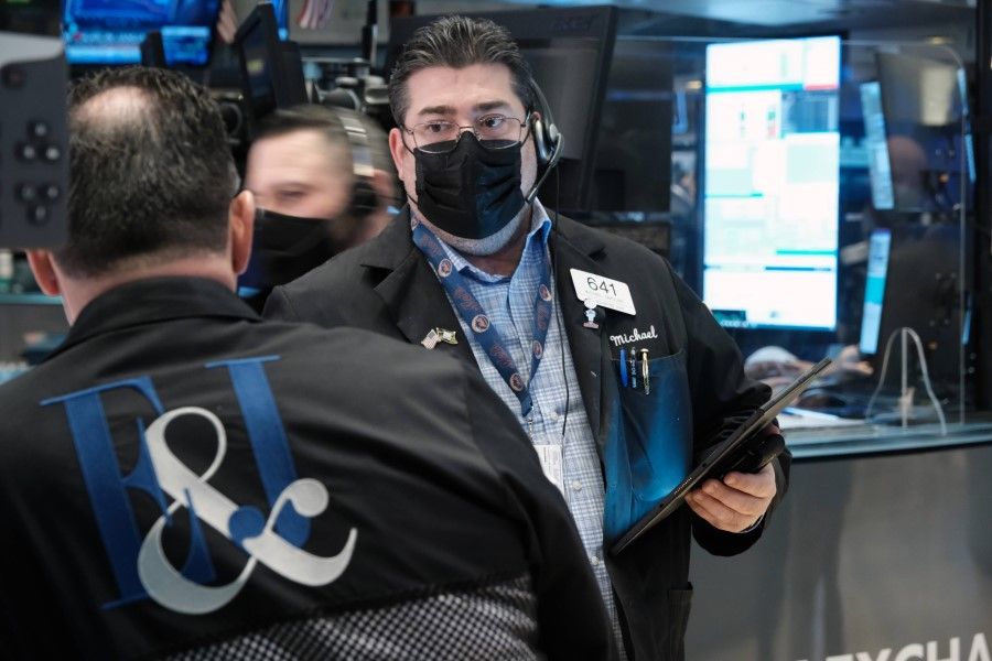 Traders work on the floor of the New York Stock Exchange (NYSE) on 31 January 2022 in New York City. (Spencer Platt/AFP)