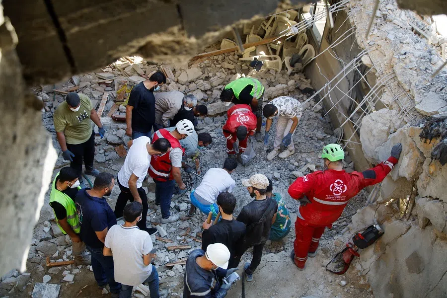 Rescuers and people inspect the site of an Israeli strike that hit a building, amid ongoing cross-border hostilities between Hezbollah and Israeli forces, in the town of Wardaniyeh, Lebanon, on 9 October 2024. (Reuters)