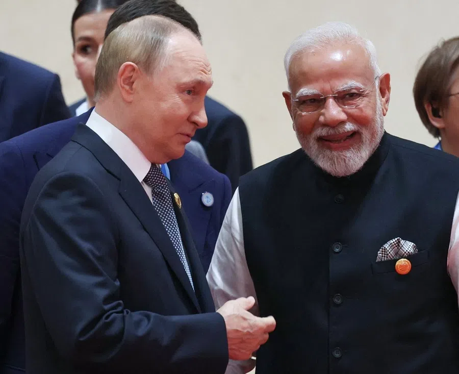 In this pool photograph distributed by the Russian state agency Sputnik, Russia’s President Vladimir Putin (L) speaks with Indian Prime Minister Narendra Modi during the Shanghai Cooperation Organisation Summit in Tianjin on 1 September 2025. (Alexander Kazakov/AFP)