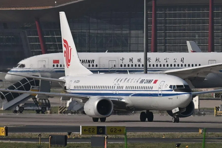 An Air China Boeing 737 MAX 8 taxis in front of an Air China Boeing 787-9 Dreamliner at Beijing Capital Airport in Beijing on 8 May 2026.