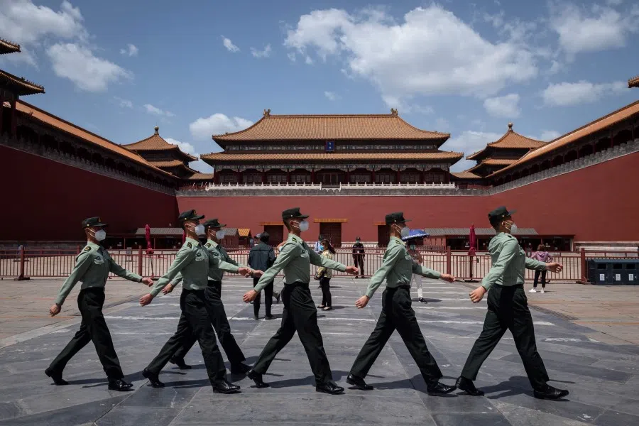 People's Liberation Army (PLA) soldiers wearing face masks walk past the entrance to the Forbidden City in Beijing, 18 May 2020. (Nicolas Asfouri/AFP)