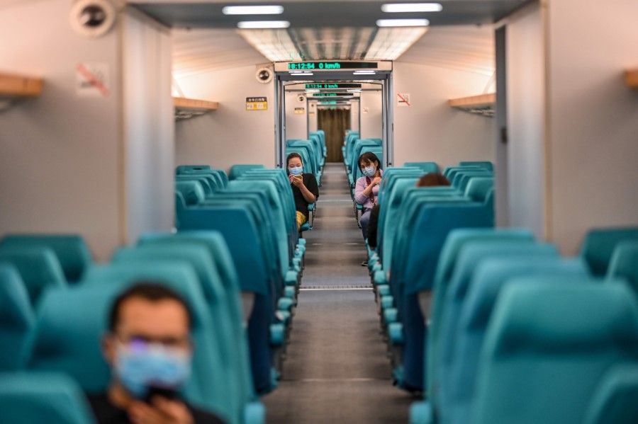 People on the Maglev high-speed train from Pudong Airport to the city of Shanghai on 11 June 2020. (Hector Retamal/AFP)