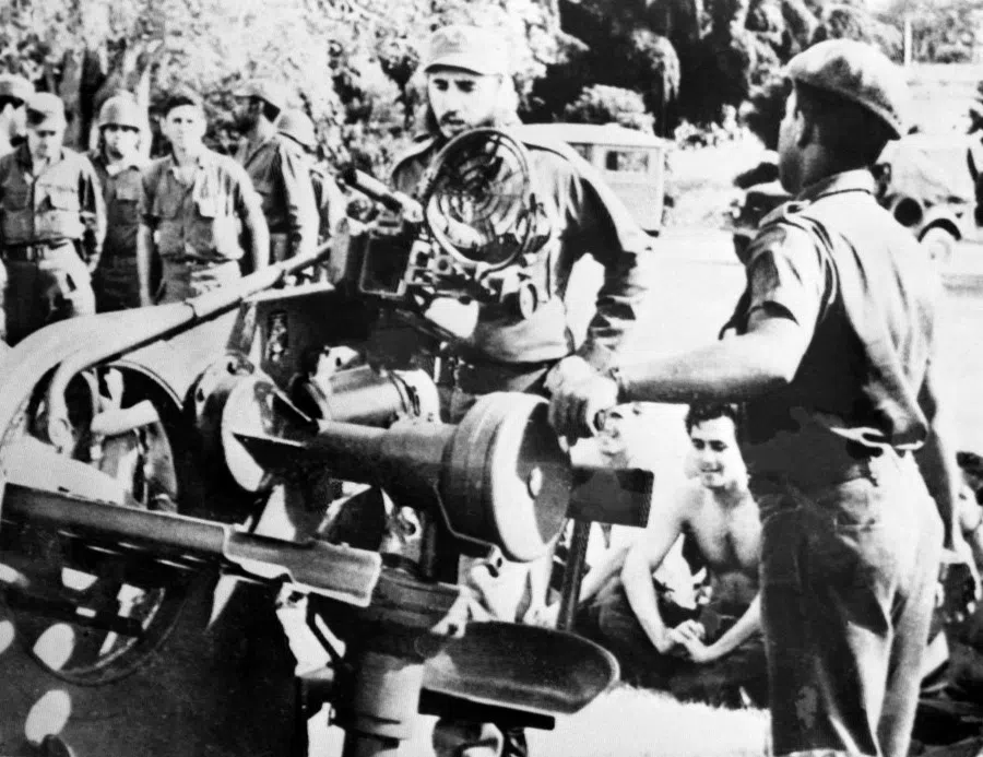 In this file photo taken on 2 November 1962, Cuban leader Fidel Castro (centre) inspects weapons in a military base during the Cuban missile crisis. (AFP)