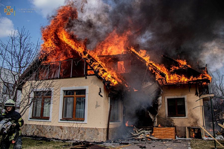 A residential house burns after shelling, as Russia's attack on Ukraine continues, in the village of Rakivshchyna, in Kyiv, in this handout picture released 24 March 2022. (Press service of the State Emergency Service of Ukraine/Handout via Reuters)